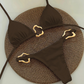 Brown bikini set with gold accents on a textured surface