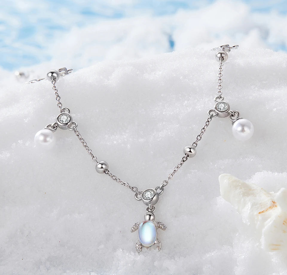 Necklace with turtle pendant on a beach setting